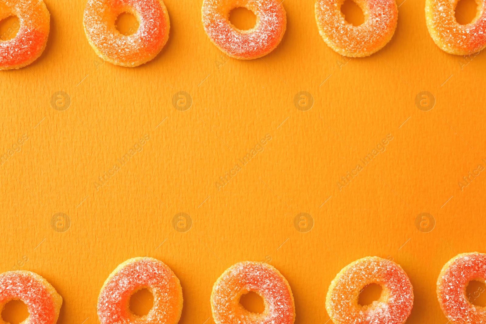 Photo of Flat lay composition with delicious jelly candies on color background. Space for text