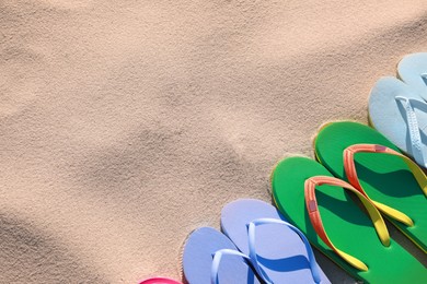 Photo of Stylish flip flops on beach, flat lay. Space for text