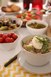 Bowl of oatmeal with poached egg, arugula and cheese served on buffet table for brunch