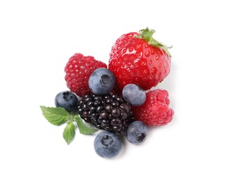 Photo of Many different ripe berries and mint leaves isolated on white