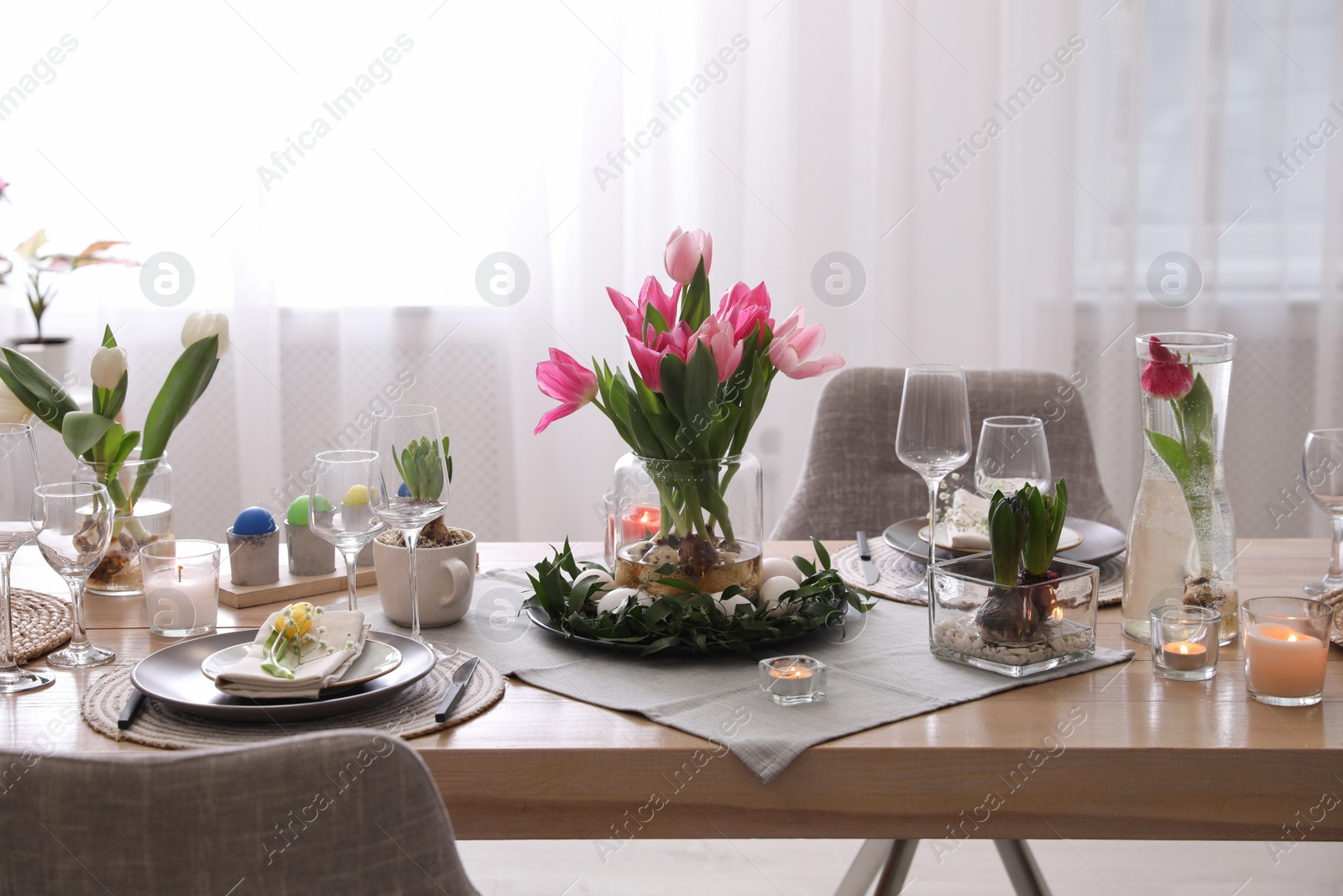 Photo of Beautiful Easter table setting with beautiful flowers indoors