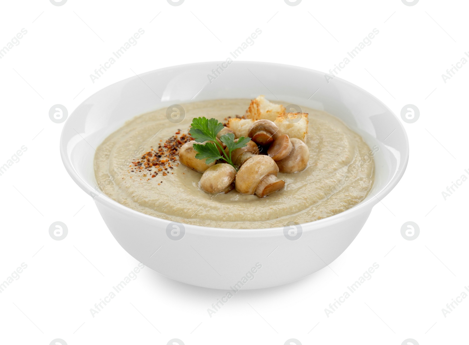 Photo of Delicious cream soup with mushrooms and croutons on white background