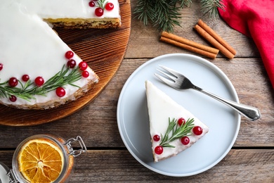 Photo of Flat lay composition with traditional Christmas cake on wooden table