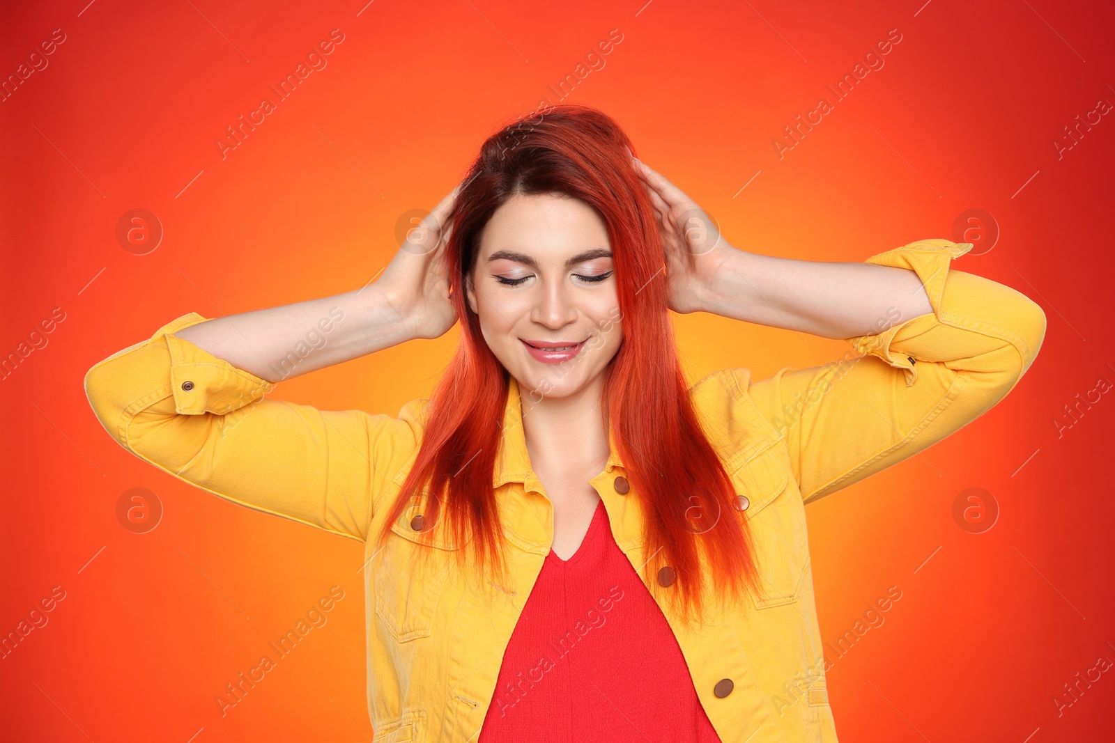 Photo of Young woman with bright dyed hair on color background