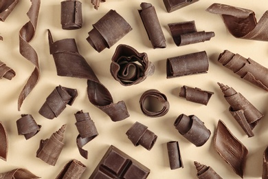 Photo of Yummy chocolate curls on color background, top view