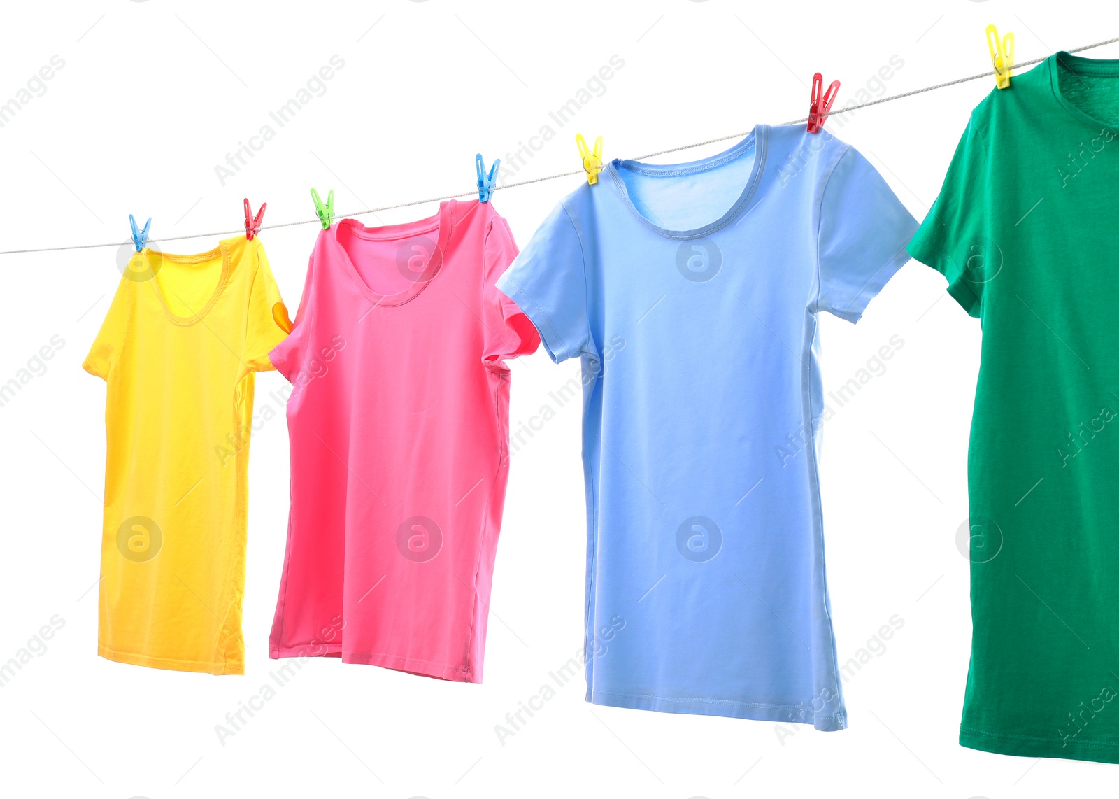 Photo of Colorful t-shirts drying on washing line isolated on white