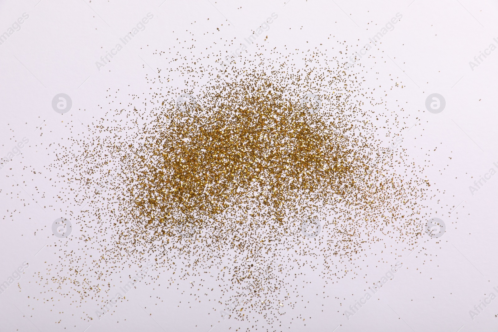 Photo of Shiny golden glitter on white background, top view