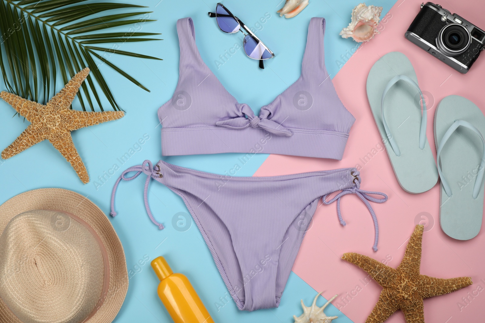 Photo of Flat lay composition with swimsuit and beach accessories on color background