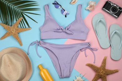 Photo of Flat lay composition with swimsuit and beach accessories on color background