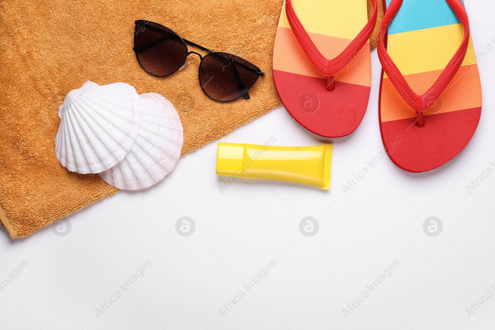 Flat lay composition with sunscreen and beach accessories on white background. Space for text Photo of Flat lay composition with sunscreen and beach accessories on white background. Space for text