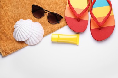 Photo of Flat lay composition with sunscreen and beach accessories on white background. Space for text