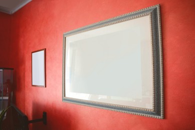Beautiful paintings on red wall in room