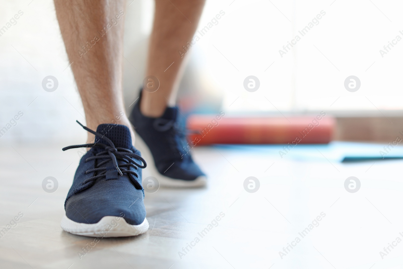 Photo of Man in training shoes indoors, closeup