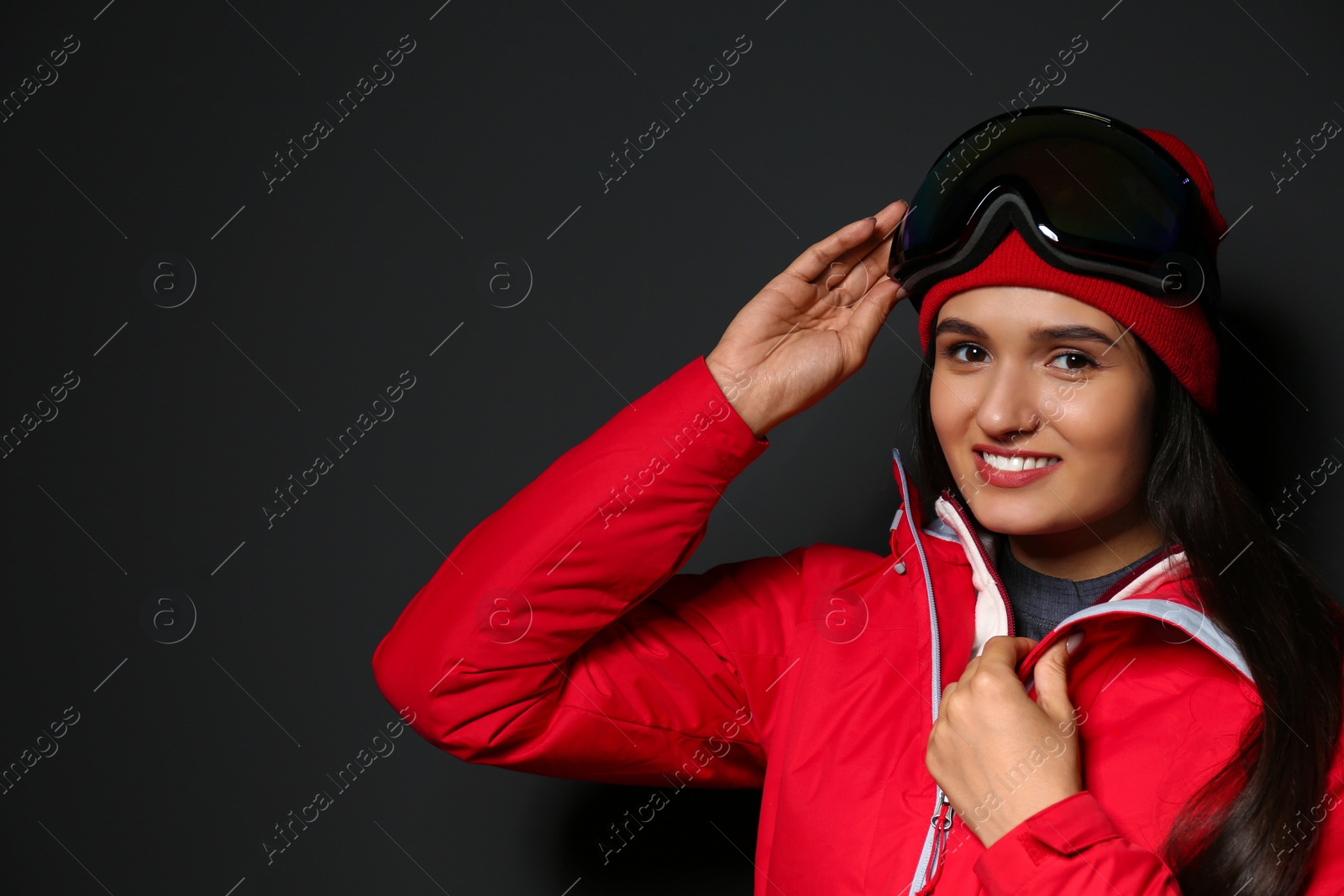 Photo of Woman wearing stylish winter sport clothes on black background