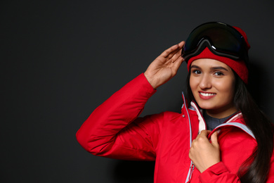 Photo of Woman wearing stylish winter sport clothes on black background
