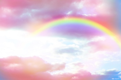 Image of Amazing sky with rainbow and fluffy clouds, toned in unicorn colors