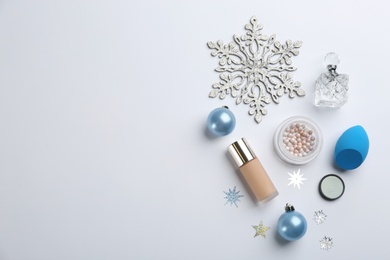 Photo of Flat lay composition with decorative cosmetic products on light background. Winter care. Space for text