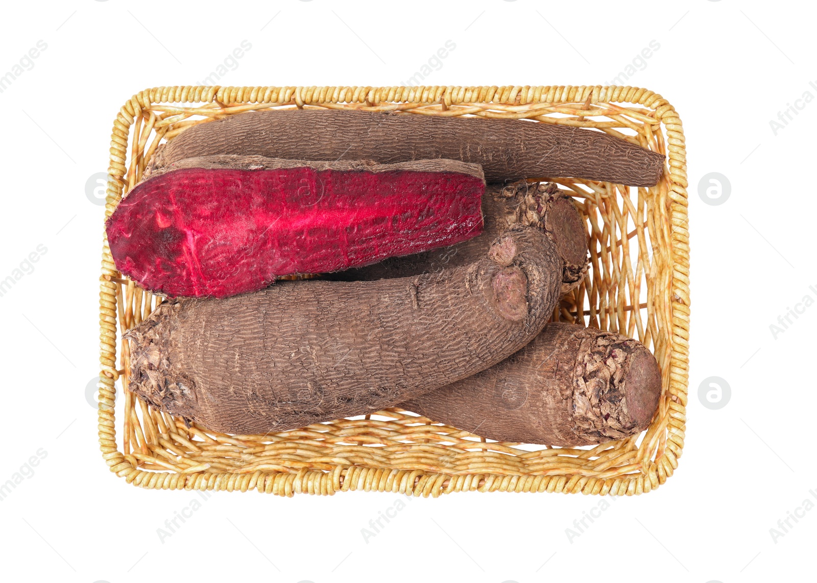 Photo of Whole and cut red beets in wicker basket isolated on white, top view