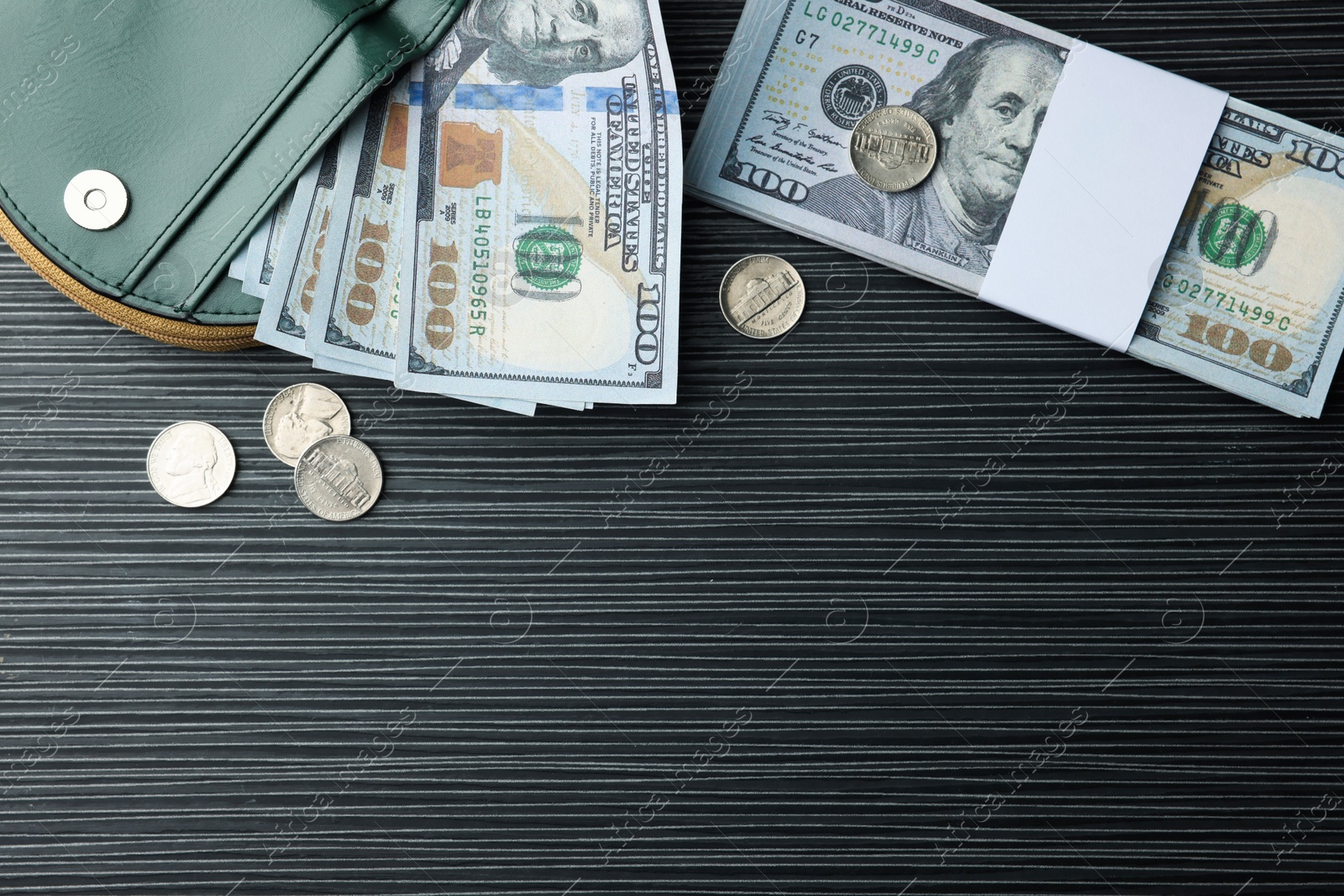 Photo of Dollar banknotes, coins and wallet on black wooden table, flat lay with space for text. Money exchange