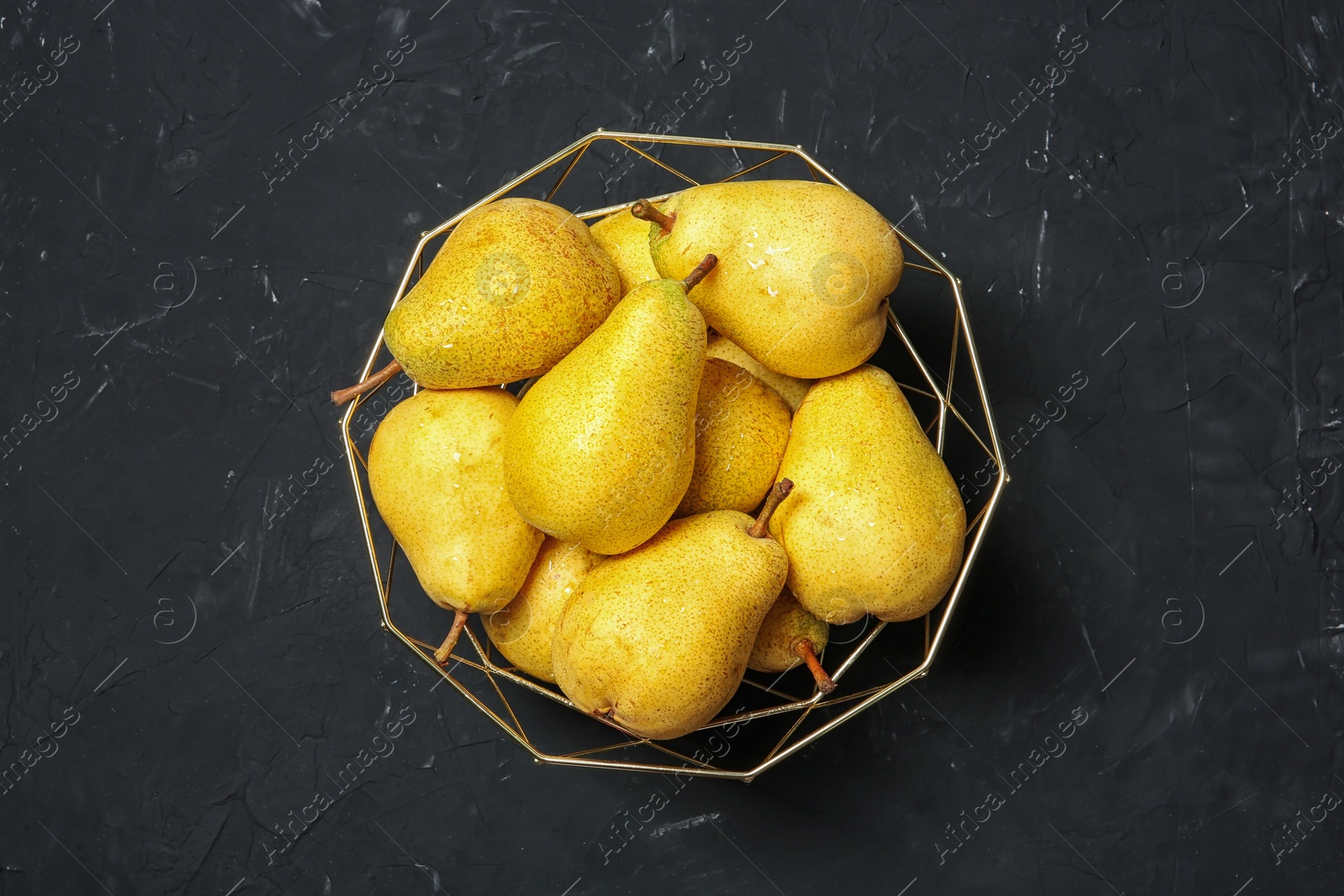 Photo of Basket with fresh ripe pears on dark background, top view