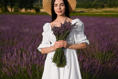 Photo of Beautiful young woman with bouquet in lavender field