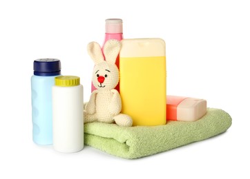 Photo of Set of baby cosmetic products, toy bunny and towel on white background