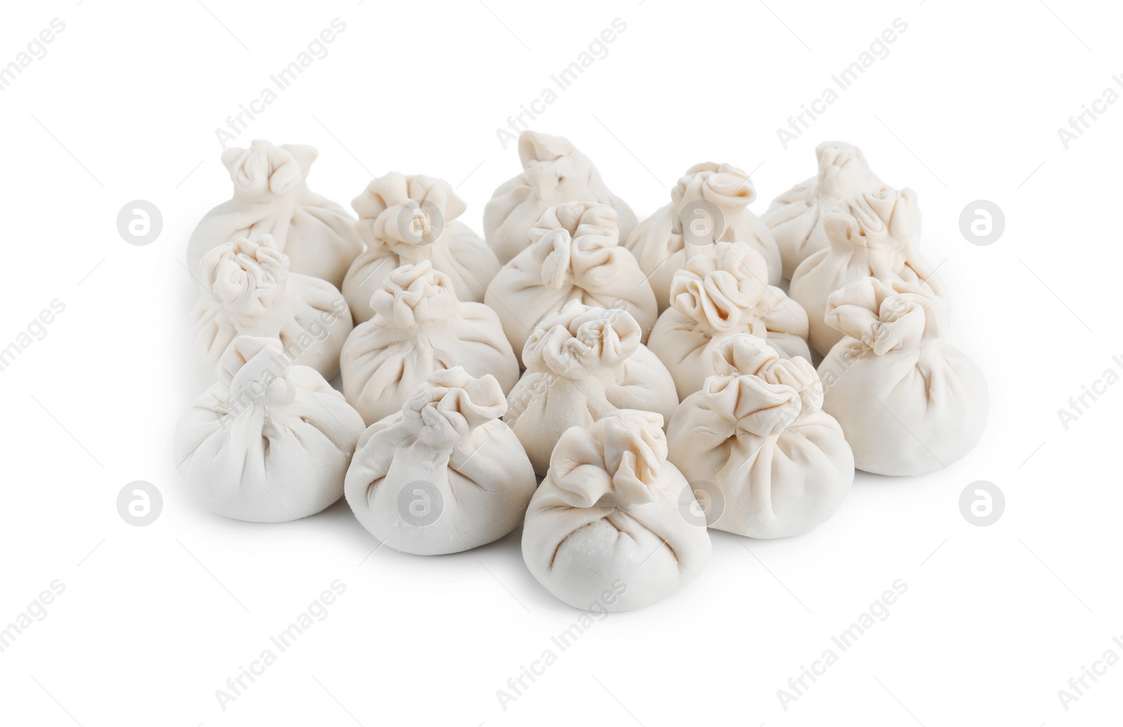 Photo of Many uncooked khinkali (dumplings) isolated on white. Georgian cuisine