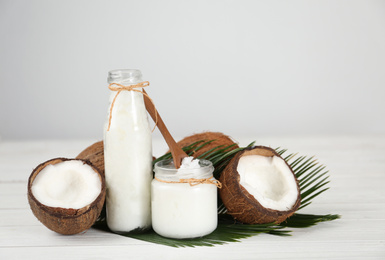 Composition  with fresh coconut oil on white wooden table. Cooking ingredient