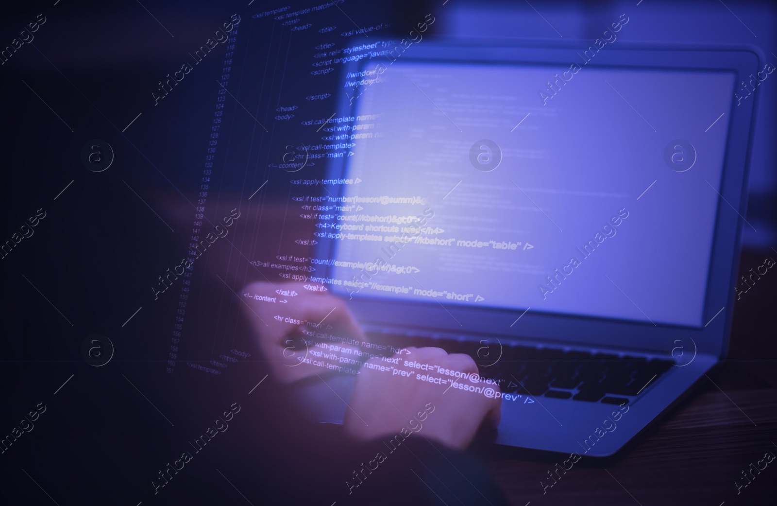 Image of Hacker working with laptop at table, closeup. Cyber attack