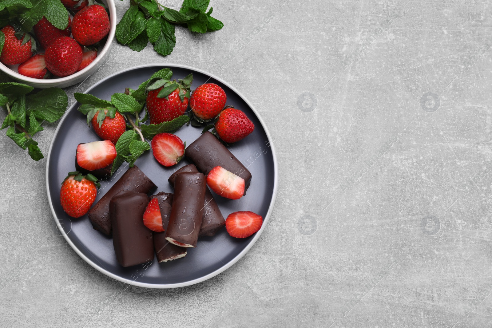 Photo of Delicious glazed curd snacks with fresh strawberries and mint on light grey table, flat lay. Space for text