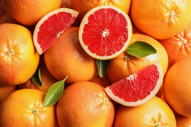 Photo of Many fresh ripe grapefruits as background, top view