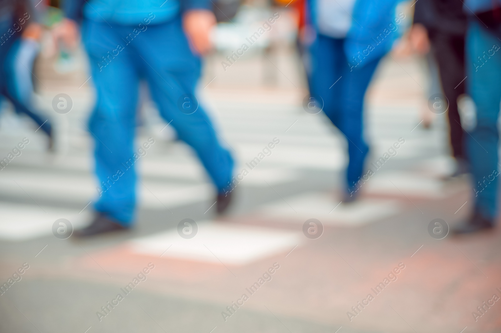 Photo of People crossing street outdoors, closeup. Blurred view