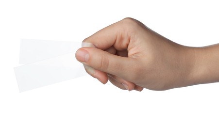 Photo of Woman holding clean microscope slide on white background, closeup