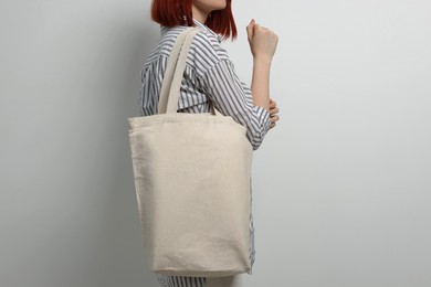 Woman with eco bag on white background, closeup