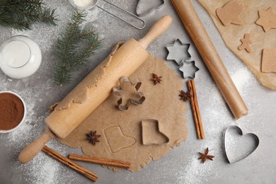 Photo of Homemade Christmas cookies. Flat lay composition with dough on grey table