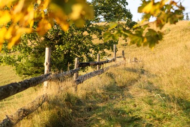 Wooden fence in countryside on sunny day