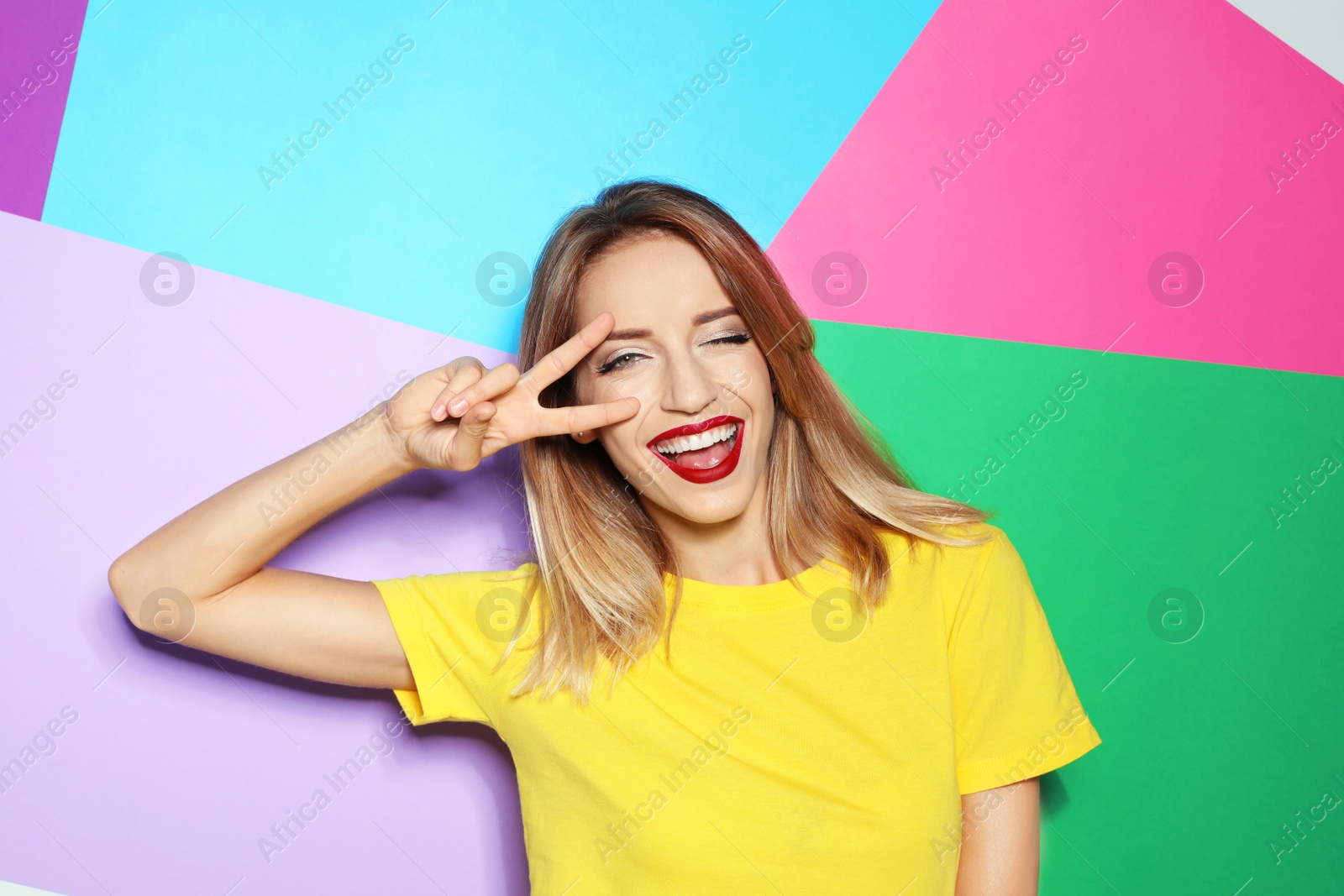 Photo of Beautiful young woman with healthy long blonde hair on color background