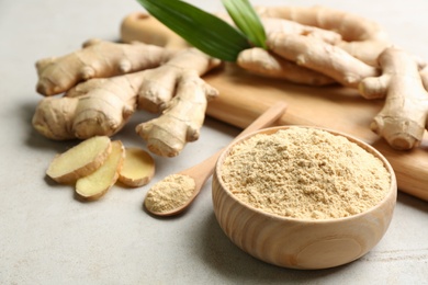 Photo of Dry and fresh ginger on light grey table, closeup