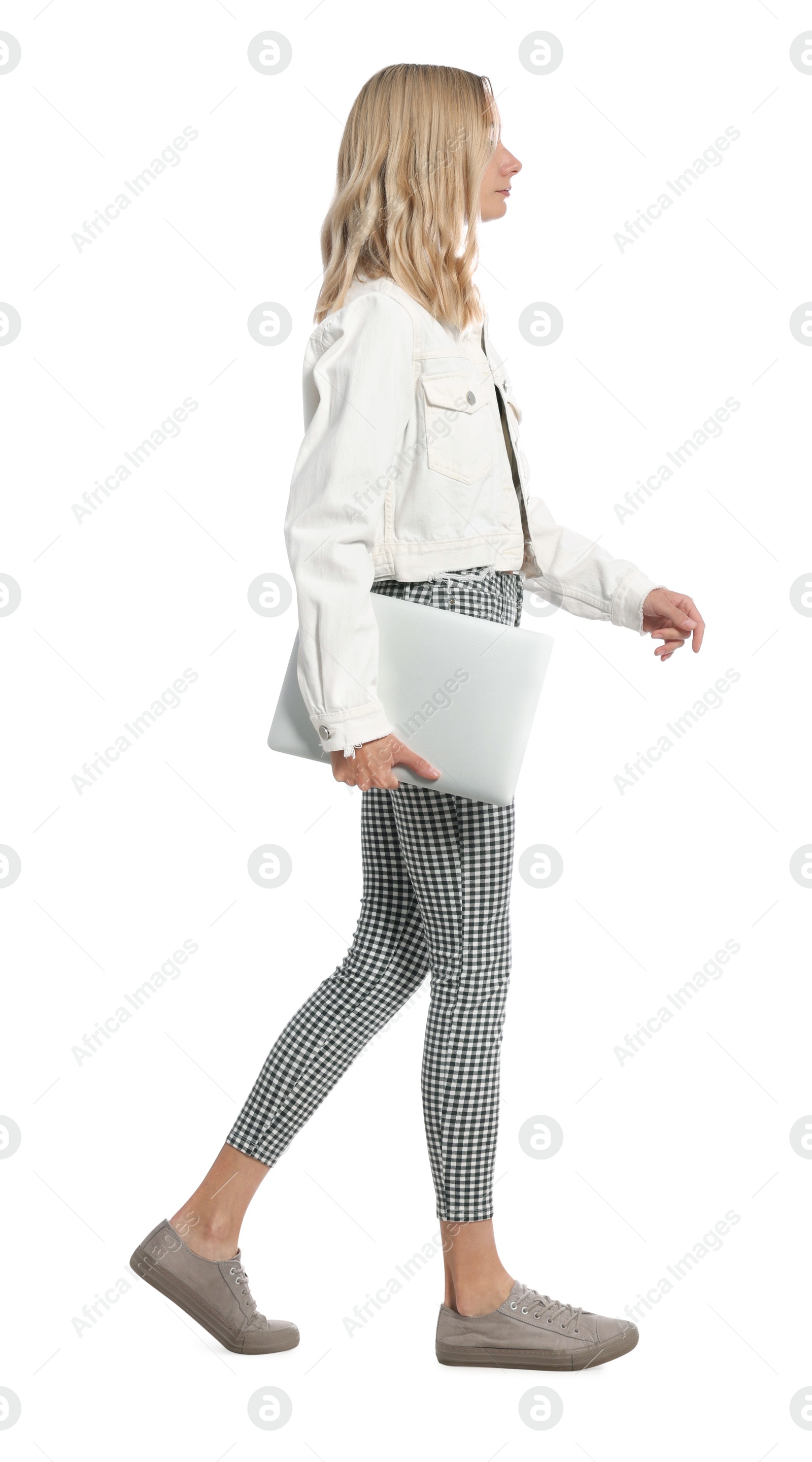 Photo of Young woman with laptop walking on white background