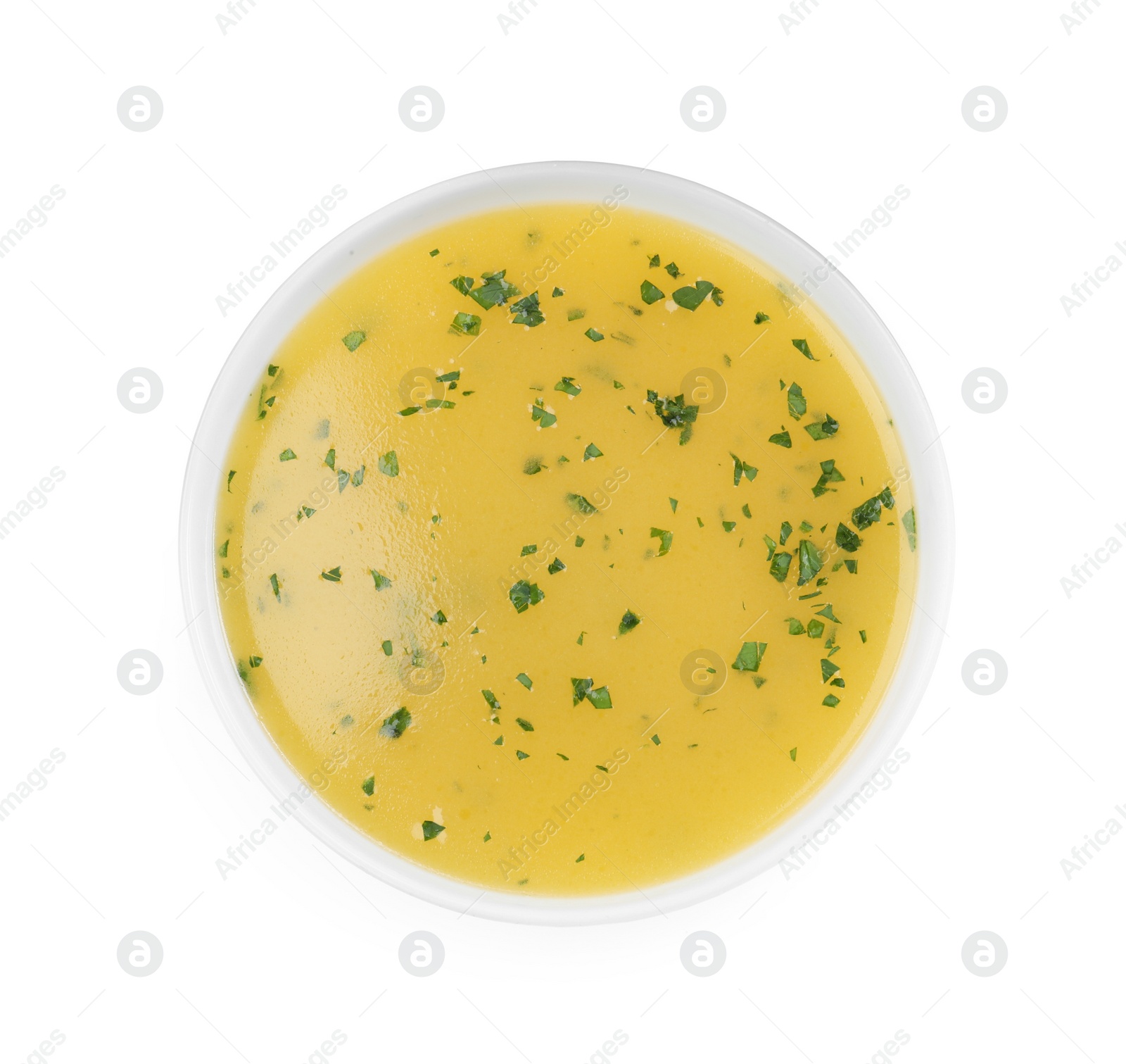 Photo of Bowl with lemon sauce on white background, top view. Delicious salad dressing