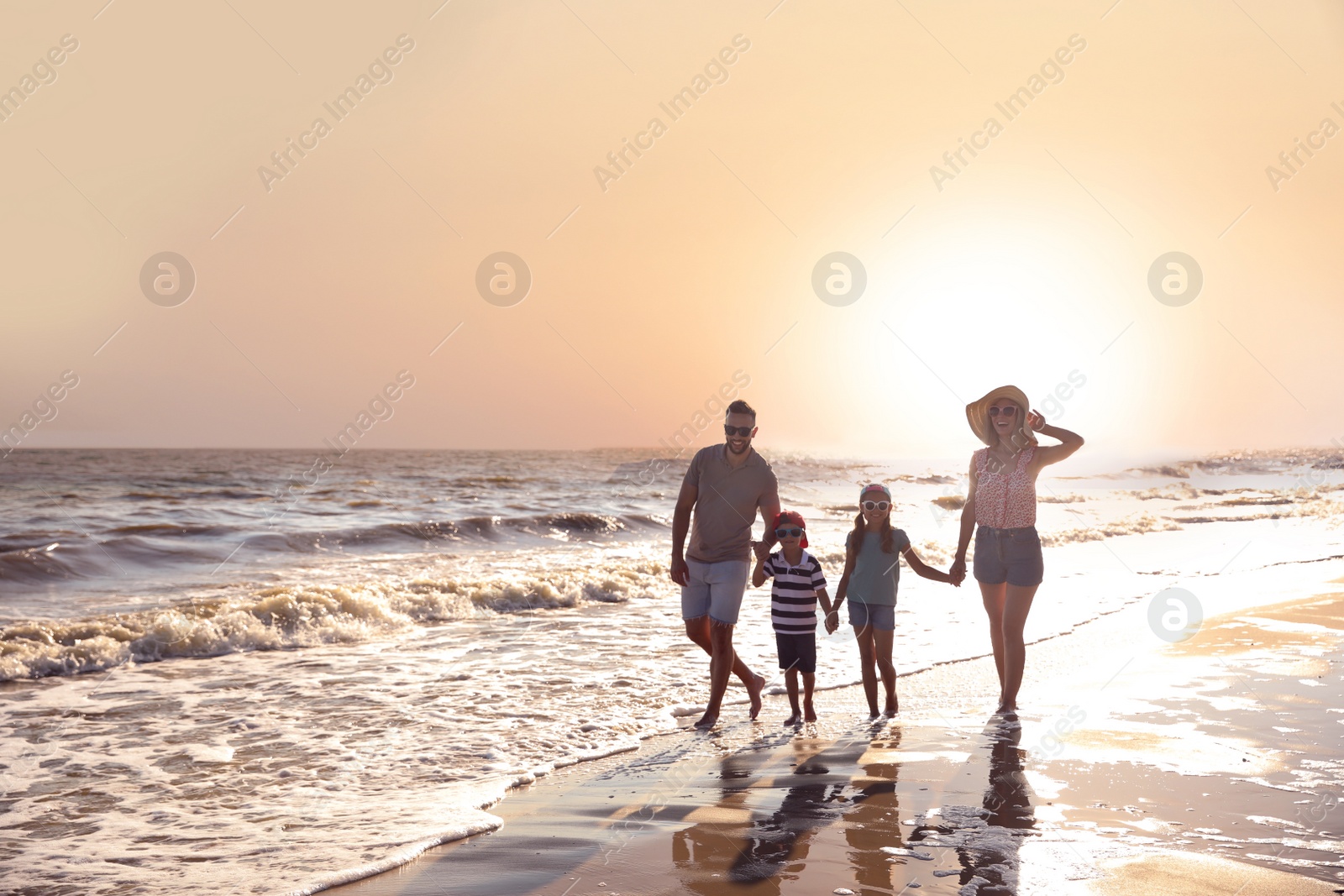 Photo of Happy family on sandy beach near sea