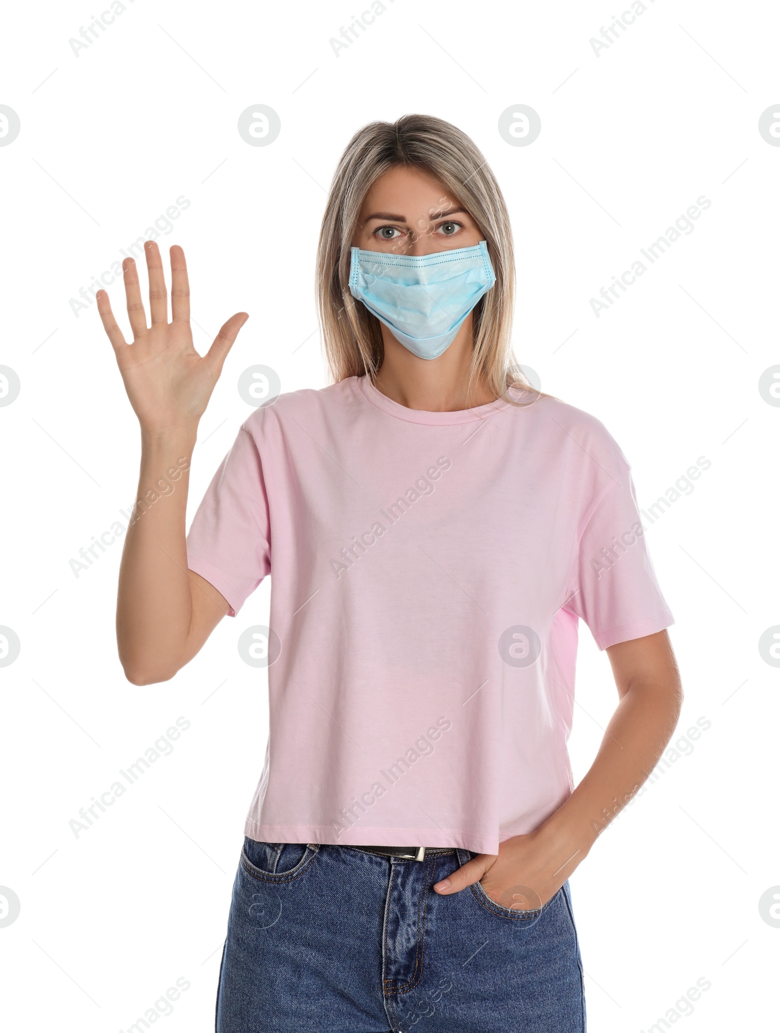 Photo of Woman in protective mask showing hello gesture on white background. Keeping social distance during coronavirus pandemic