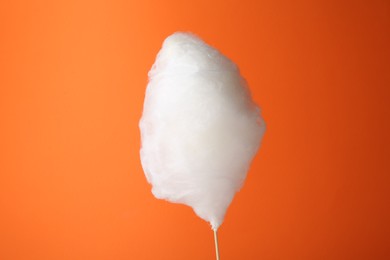 Photo of One sweet cotton candy on orange background