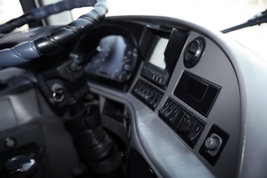 Photo of Professional driver's cab in modern bus, view of dashboard