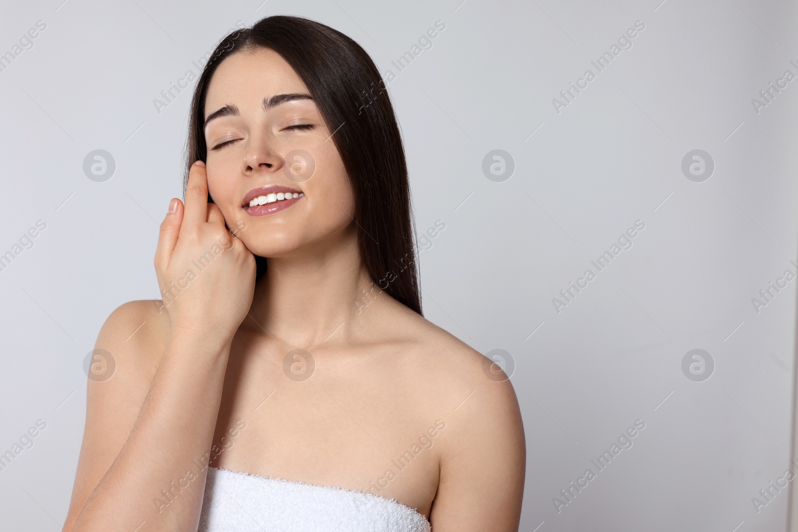 Photo of Portrait of attractive young woman on light grey background, space for text. Spa treatment
