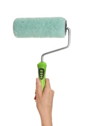 Woman holding paint roller brush on white background, closeup