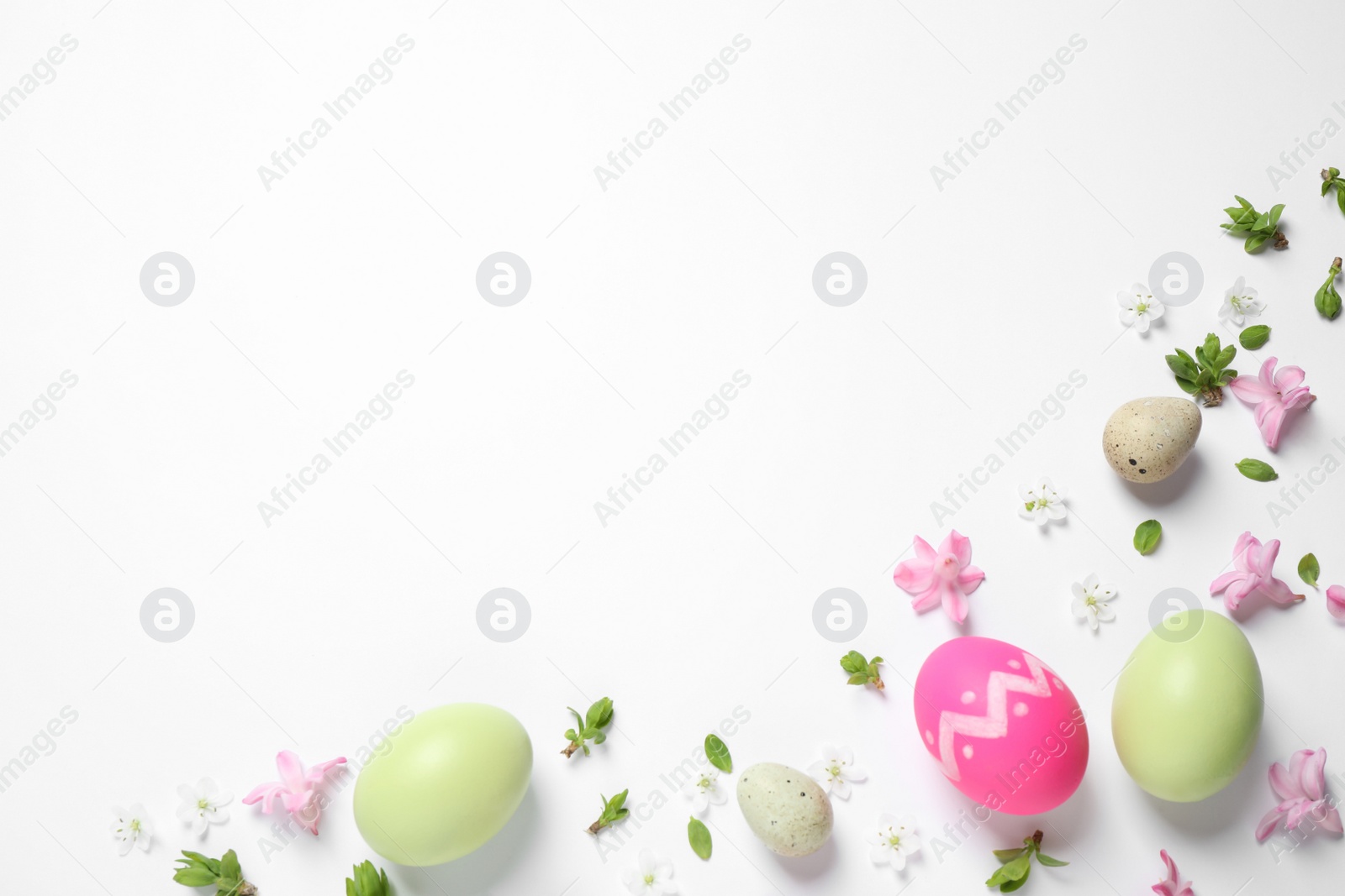 Photo of Flat lay composition with Easter eggs on white background. Space for text