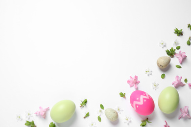 Flat lay composition with Easter eggs on white background. Space for text