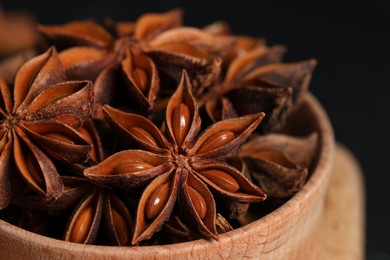Photo of Aromatic anise stars in bowl, closeup view