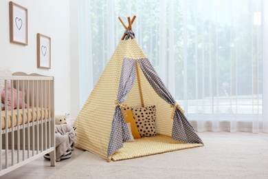 Cozy baby room interior with play tent and toys